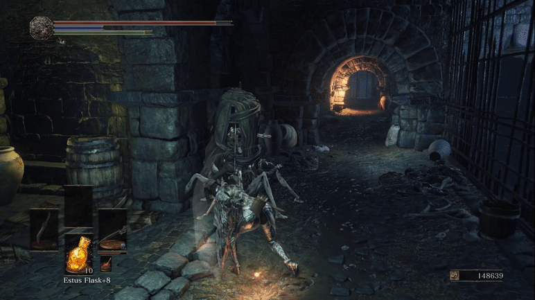 A well-armored women swings a wrist-mounted blade at a cage full of reanimated corpses. Blood shoots out when it is struck, and after several hits, an explosion of blood gushes from it.