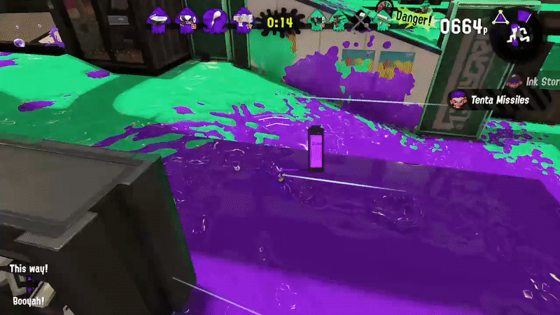 A girl with octopus arms for hair in a white T-shirt runs through an office complex with floors and walls drenched with green and purple ink. With a giant paintbrush she leaves behind purple ink as she goes. Several ink-bombs go off around her before a countdown timer reaches zero, as a barrier of caution tape with the word "Game!" written on each piece covers the screen.