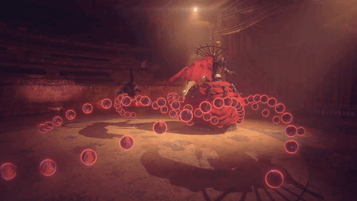 A decaying giant robot puppet spins like she is dancing, in an opera hall. A much smaller android in a black dress dexterously bounds over and around a stream of energy orbs unleashed from the puppet, then strikes her with a sword.